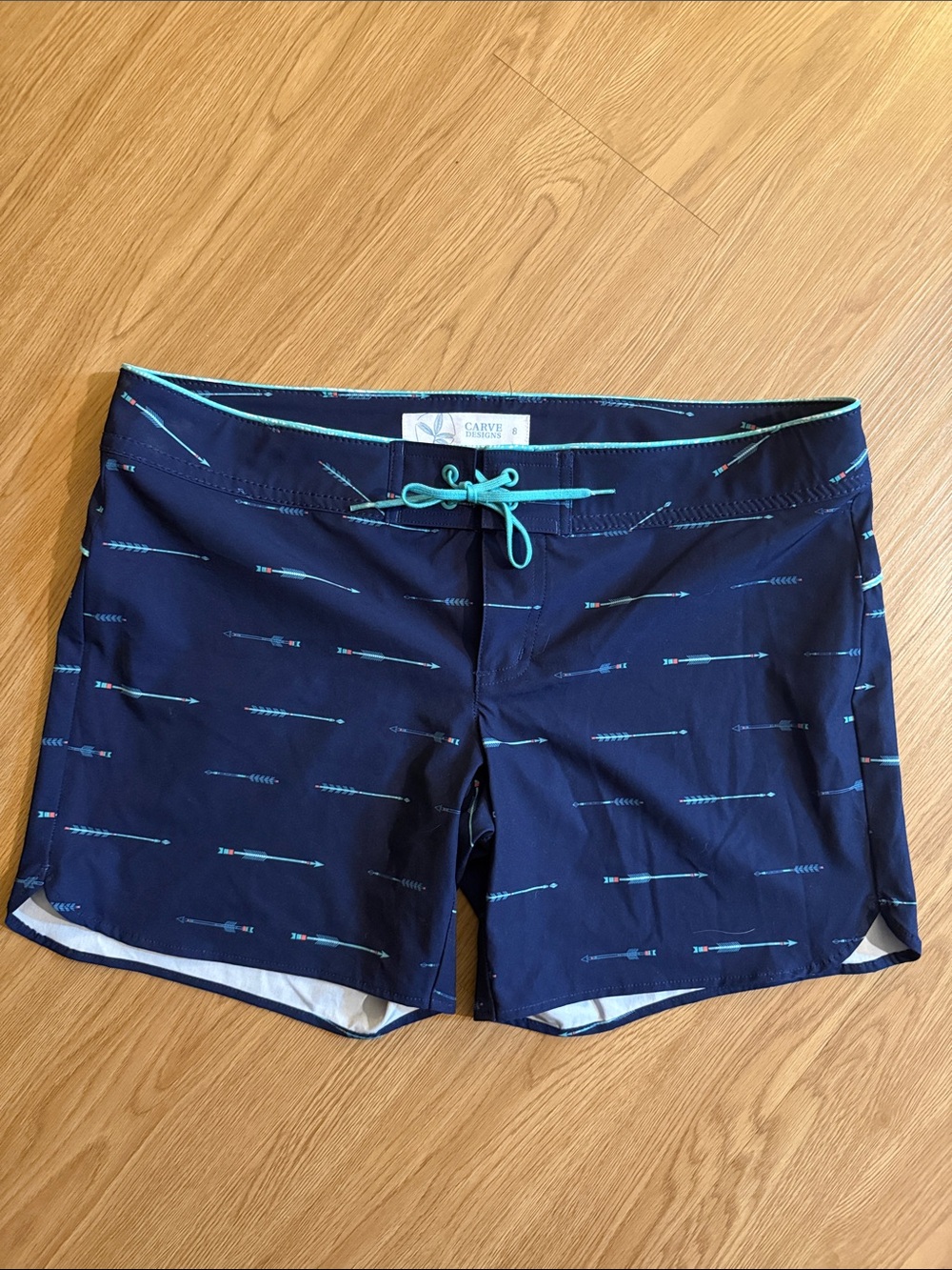 Carve Designs Unlined Navy Swim Shorts with Teal Arrow Accents